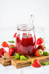 Strawberry jam in the glass jar.