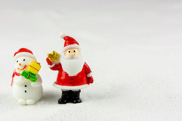 Merry Christmas and happy new year concept. Cute santa claus figure and tree on snow with copy space