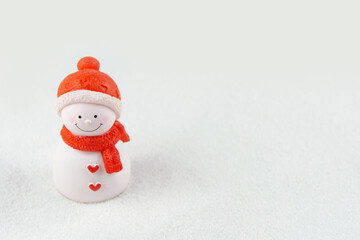 Merry Christmas and happy new year concept. Cute snowman figure on snow with copy space