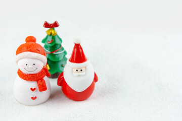 Merry Christmas and happy new year concept. Cute santa claus figure and tree on snow with copy space