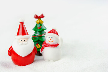 Merry Christmas and happy new year concept. Cute santa claus figure and tree on snow with copy space