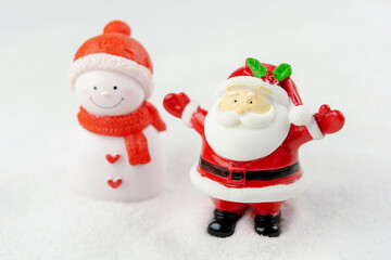 Merry Christmas and happy new year concept. Cute santa claus figure and tree on snow with copy space
