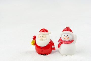 Merry Christmas and happy new year concept. Cute santa claus figure and tree on snow with copy space
