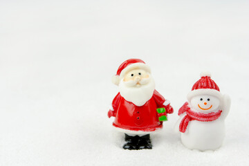 Merry Christmas and happy new year concept. Cute santa claus figure and tree on snow with copy space