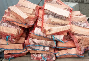Papier Peint photo Autocollant Texture du bois de chauffage Stack of birch firewood packed in a net for sale