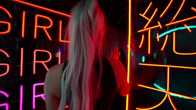 peep show and striptease woman with long blonde hair and slender sexy body, back view