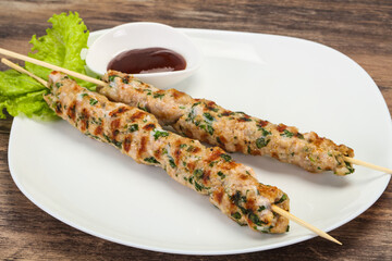 Minced pork skewer kebab with sauce
