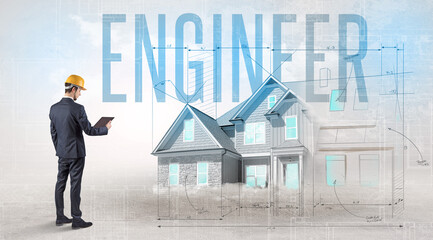 Young engineer holding blueprint with ENGINEER inscription, house planning concept