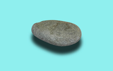Grey sea smooth stone isolated on a turquoise background.