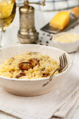 Risotto with porcini mushrooms, Parmesan cheese, Pecorino, onion, garlic, olive oil, dry white wine, freshly ground black pepper and aborio rice. Traditional dish of Mediterranean (Italian) cuisine