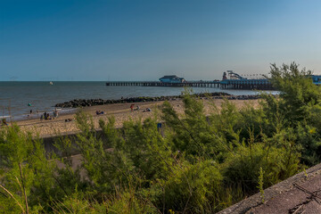 Fototapeta na wymiar An early evening view from the cliff path along the beach at Clacton on Sea, UK in the summertime