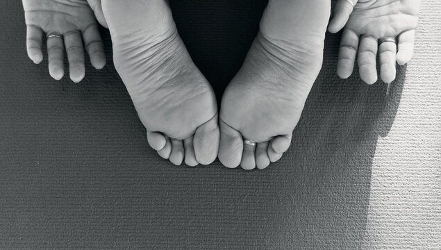 Uttitha balasana happy child's pose, iyengar yoga relaxing baby asana in the studio, details of legs and hands - Powered by Adobe