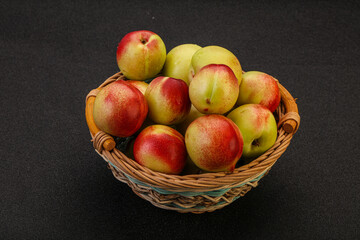 Sweet small nectarines in the basket
