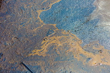 Ecological catastrophy. Close-up. Spill of oil products into the sea. Poisonous oil products float on the surface of the clean sea.