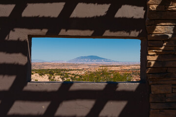 Shadows on wall around around window in viewing platflorm across Arizona landscape.