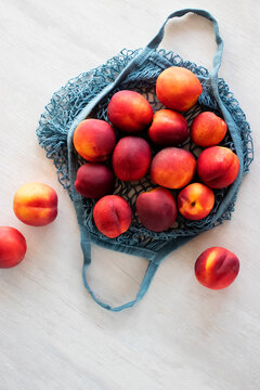 Nectarines In Blue Eco String Bag. Zero Waste Concept.