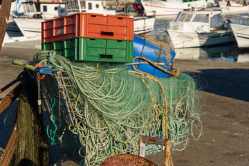 Rusty fishing gear and nets on a pier in Setubal, Portugal