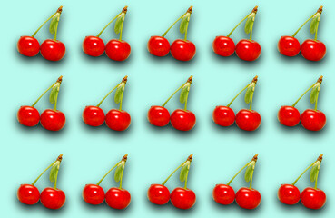 Pattern with ripe cherry berries on a turquoise background.