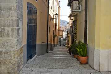 A narrow street among the old houses of San Bartolomeo in Galdo, a rural village in the Campania region, Italy.
