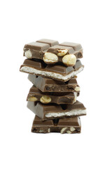 The chocolate pieces of different types stacked on white background.