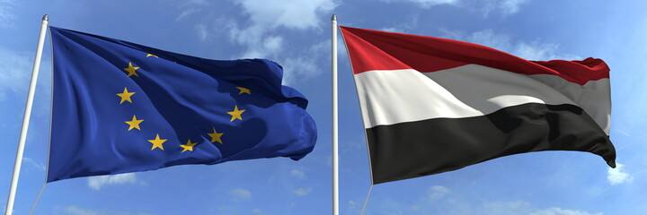 Flags of the European Union and Yemen on flagpoles. 3d rendering