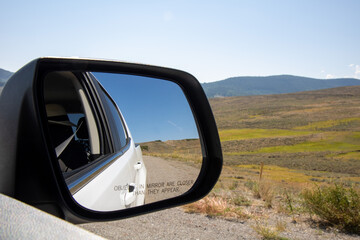 Car Mirror reflecting travel scenery