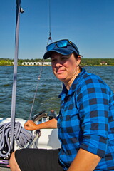 Portrait of a young yachtswoman driving a yacht