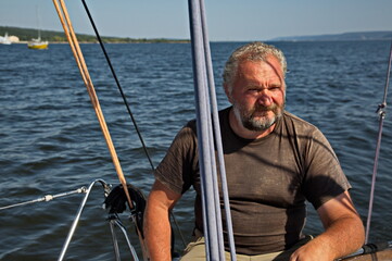 Portrait of an experienced yachtsman driving a yacht.