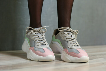 beautiful female legs wearing sport shoes close up