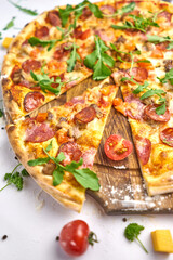 Italian pizza with pepperoni, mozzarella and tomato sauce wooden table