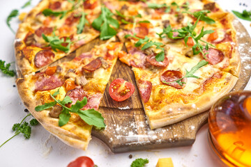 Italian pizza with pepperoni, mozzarella and tomato sauce wooden table