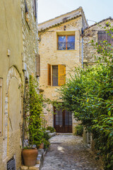 Fototapeta na wymiar Medieval Stone houses in famous village of Saint-Paul-de-Vence. Saint-Paul-de-Vence - commune in Alps-Maritimes department in southeastern France - one of oldest medieval towns on the French Riviera.
