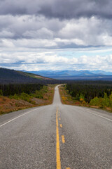 Fototapeta premium Scenic Route, Alaska Hwy, during a sunny and cloudy day. West of Whitehorse, Yukon, Canada.