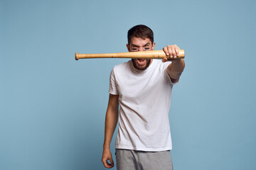 emotional man with a bat in his hand on a blue background and makeup on his face black lines energy t-shirt baseball
