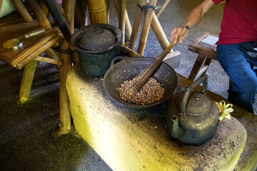 The man making coffee in Bali in traditional way. 