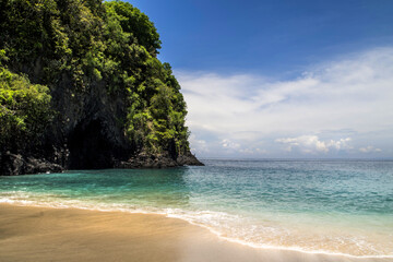 Balinese White Sand Beach with the waves in a sunny day, Bali, Indonesia.  
