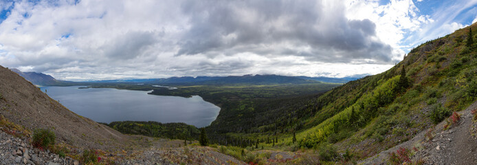 Panoramic View of Canadian Mountain Landscape during a cloudy morning sunrise. Kluane National Park, Yukon, Canada. Nature Background Panorama