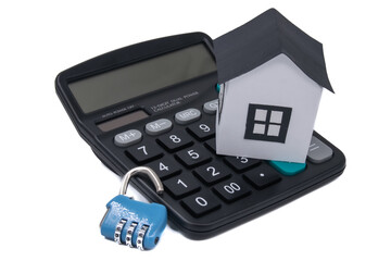 The toy house and code lock on a calculator isolated on white, mortgage calculator