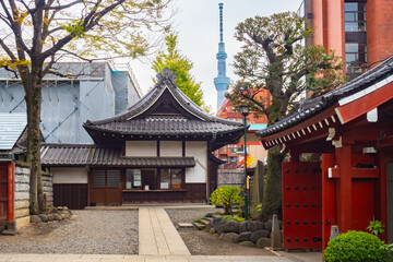 Diverse Japan. Walk around Tokyo. View of the TV tower from the Asakusa temple. Religious and ordinary buildings in the Japanese capital. Tokyo in the fall.