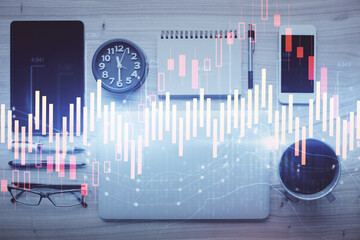 Double exposure of forex graph hologram over desktop with phone. Top view. Mobile trade platform concept.