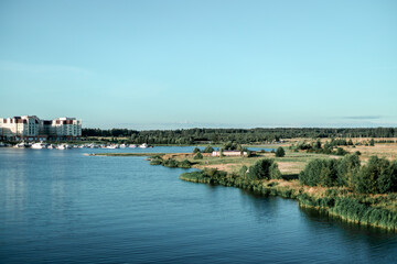 Fototapeta premium View of the city on the river on a sunny day