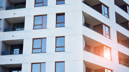 Architectural details of modern apartment building. Modern european residential apartment building complex. Sunset.