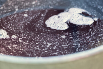 Grape juice close up during the autumn harvest. Traditional old technique of wine making. Filtering grape must.