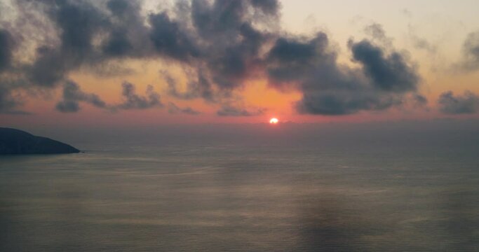 Sunset over sea on ionian Island in Geece. Slow moving clouds above