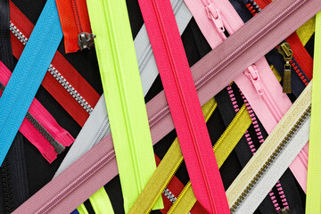 Zip background texture of zippers sliders. a lot of zippers in different colors. sewing clothes,...