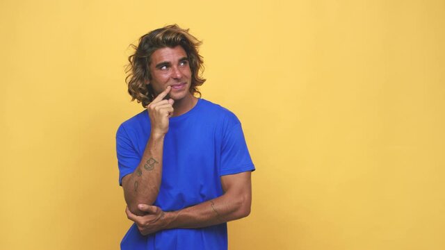Young cool australian man relaxed thinking about something looking at a copy space