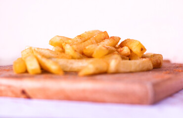 french fries on wooden board.