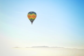 A single hot air balloon over Napa Valley at sunrise