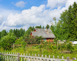 Fototapeta na wymiar Old wooden village house in summer day