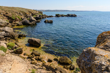 Fototapeta na wymiar Sea bay and rocky coast on a sunny day. Seascape.